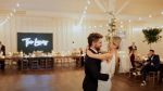 Chris Lane and his wife Lauren dancing at their wedding
