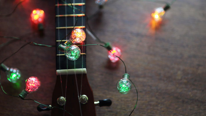 Guitar with Christmas lights draped on it