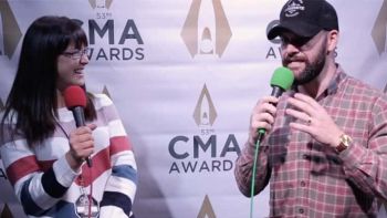Dylan Scott talks with Cara at the CMA Awards