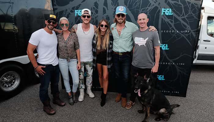 Florida Georgia Line's Tyler Hubbard, Brian Kelley, Brittney Kelley, and IMPD Police Officer with K9 Sarge at FGL Fest