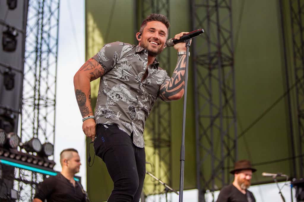 Michael ray singing on stage with camouflage shirt on