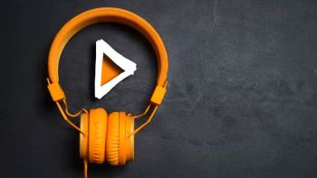 Orange headphones on a black background