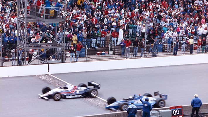 Al Unser Jr and Scott Goodyear cross the Indianapolis 500 line under the checkered flag in historic finish