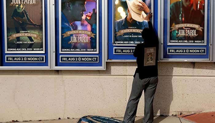 Jon Pardi music video posters being put up