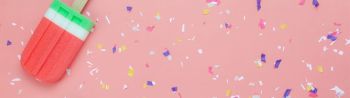 Popsicles on a pink background with confetti