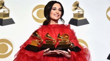Kacey Musgraves holding her 4 Grammy awards