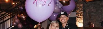 Katelyn Jae and Kane Brown holding purple balloon with Kingsley written on it