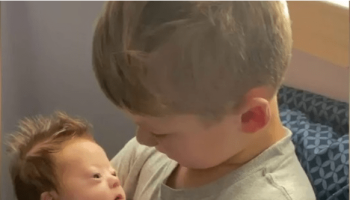 Boy sings to baby brother with Down Syndrome