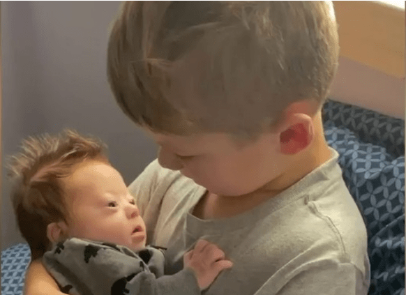 Boy sings to baby brother with Down Syndrome