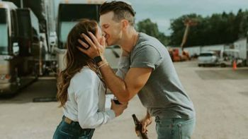 Russell Dickerson and his wife Kailey Dickerson kissing