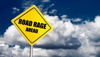 Road rage sign over cloudy sky