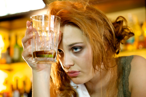 Girl holding drink who had too much to drink