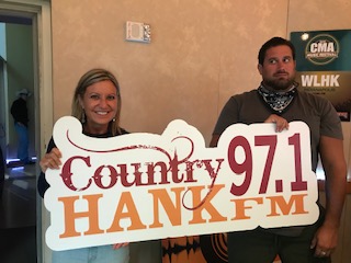 Mindy and Caleb holding HANK-FM Sign