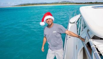 Kenny Chesney on a boat with Santa Hat