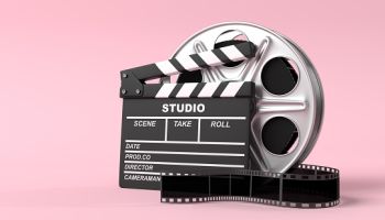 Film reel with clapperboard isolated on bright pink background