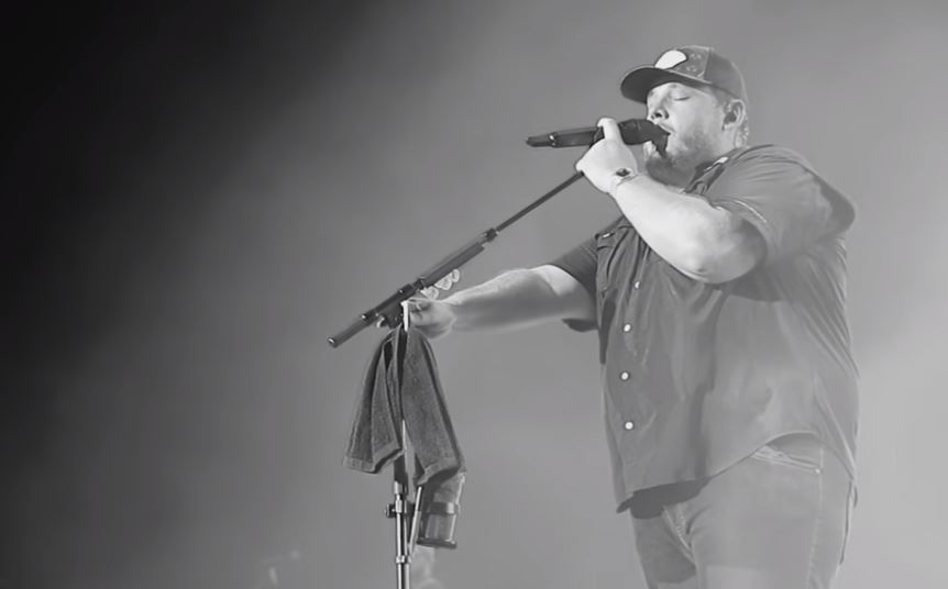 Luke Combs singing in microphone