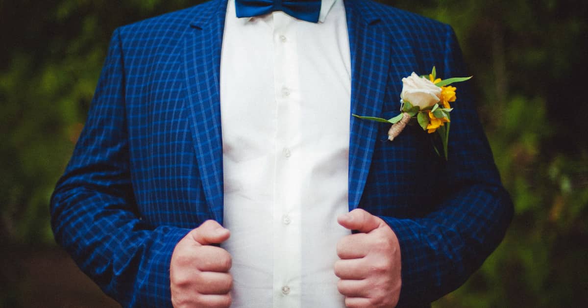 Groom holding his blue jacket