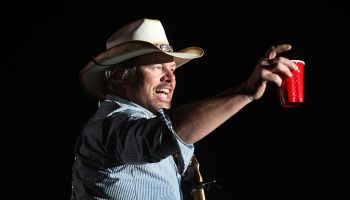 Toby Keith toasts his fans with a red solo cup, the name of one of his hit songs on the Mane Stage