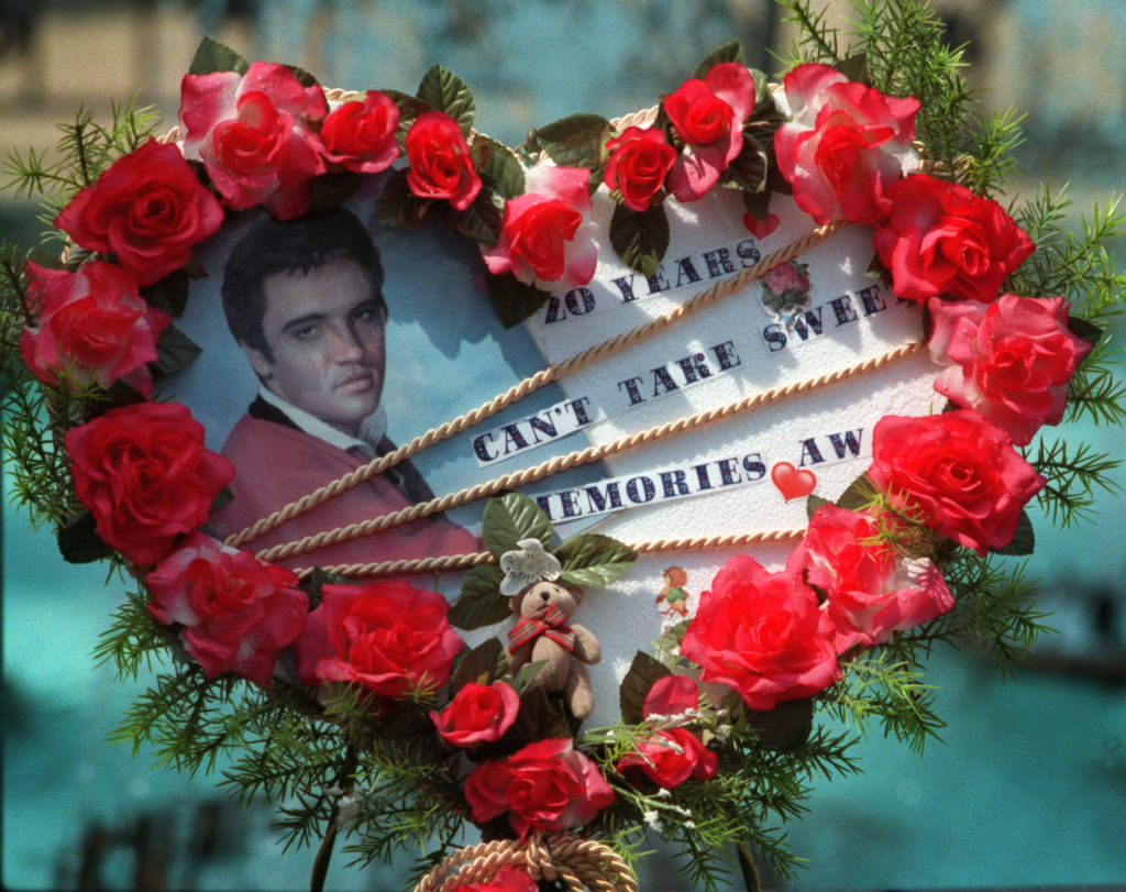 A a flower arrangement left by a fan at the gravesite of Elvis Presley at Graceland.