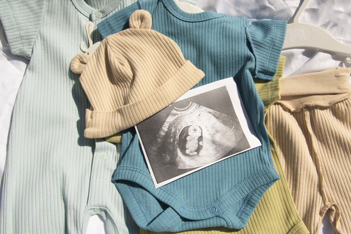 ultrasound photo of baby on children's clothes for newborn boy.