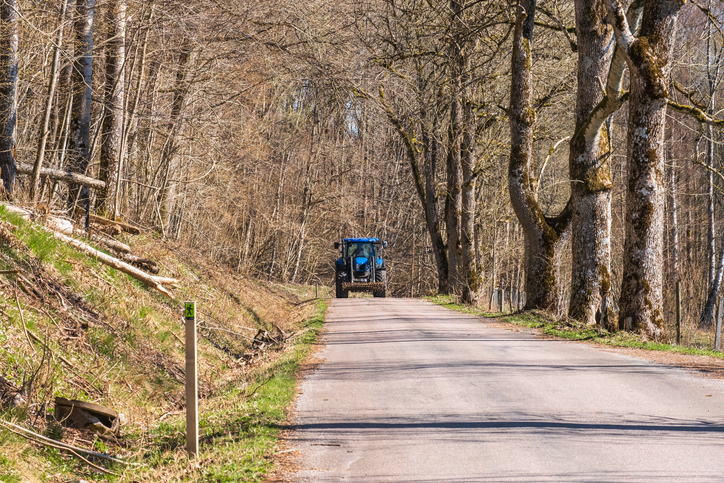 Tractor on a road in the woods