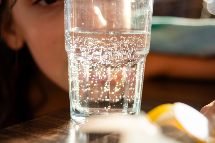 Sparkling water whit a girl in the background