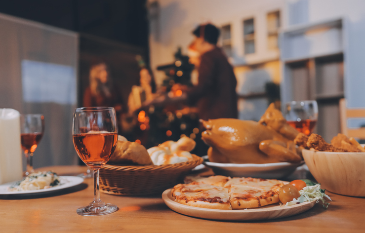 Festive Office Christmas Party with Delicious Food. A beautifully decorated office space with Christmas trees and festive lights, set up for a holiday party.