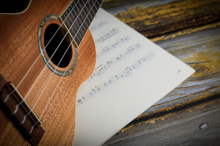 acoustic guitar and music notes on wooden