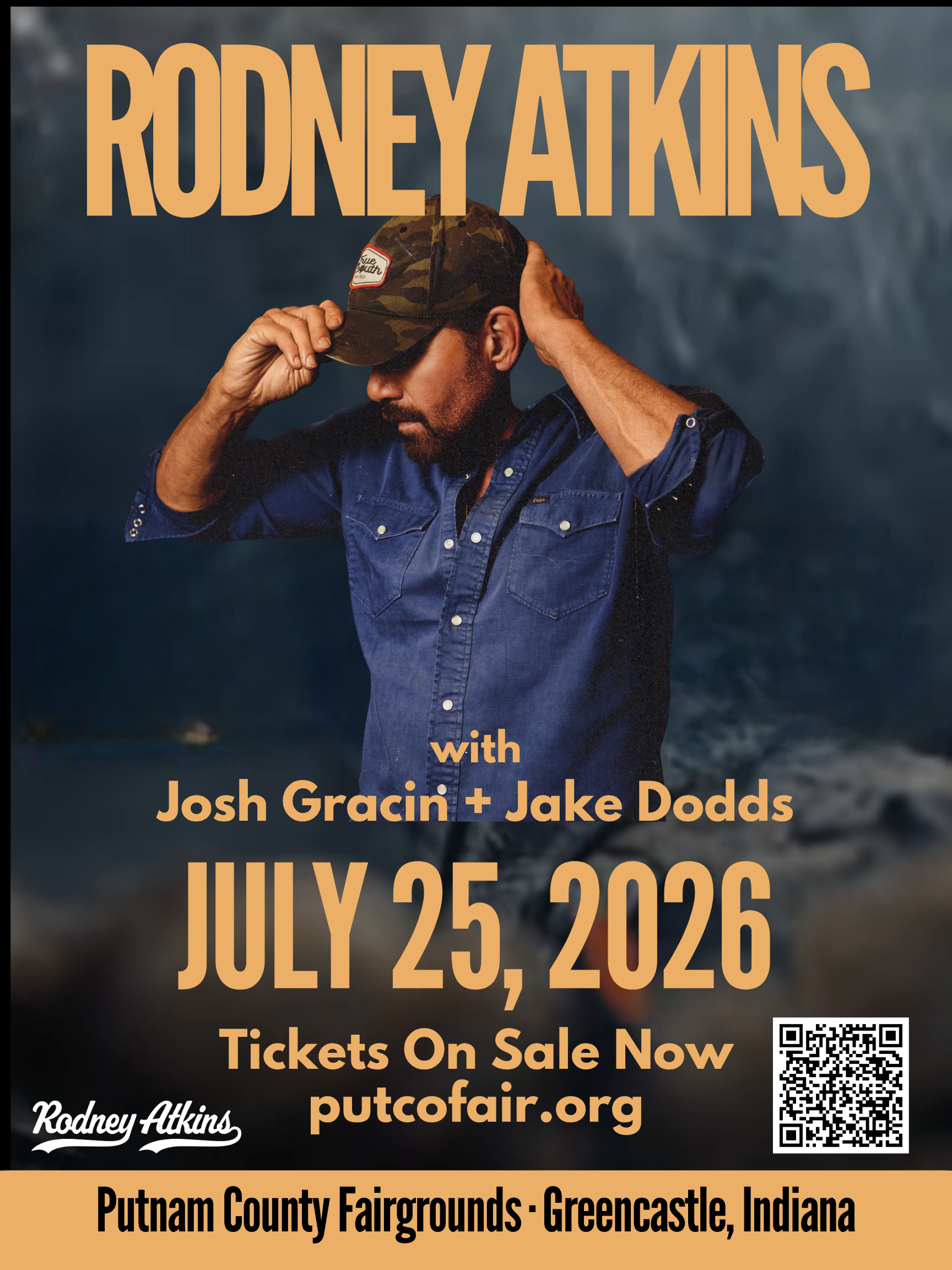 A bearded man in a camouflage hat and denim shirt stands in front of a poster for a Rodney Atkins concert on July 25, 2026 at the Putnam County Fairgrounds in Greencastle, Indiana.