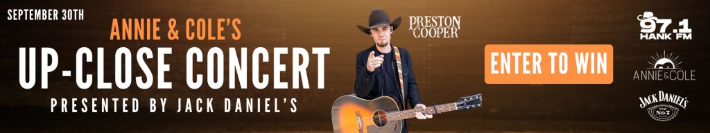 A man in a cowboy hat playing an acoustic guitar on a concert stage, with text promoting an "Annie & Cole's Up-Close Concert" event presented by Jack Daniel's.